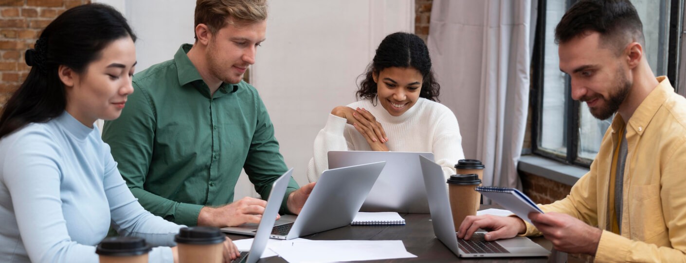 team gathering and planning and seeing laptop screen